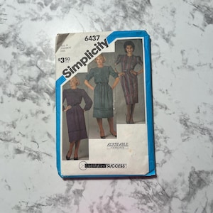 May include: Vintage Simplicity sewing pattern, size N, featuring three dress designs. The pattern envelope is white with a blue border and includes the text "Simplicity" and "Overnight Success."