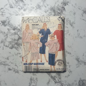 May include: A vintage McCall's sewing pattern titled "Non-Stop Wardrobe." The pattern features illustrations of various clothing items, including tops, skirts, and pants. The pattern's cover has text in English and French.