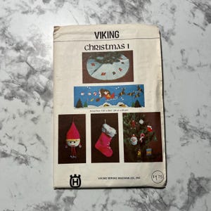 May include: A vintage sewing pattern for a Christmas tree skirt, stocking, elf, and ornaments. The pattern is from Viking Sewing Machine Co. and costs $1.75. The pattern includes instructions for making a 13-inch by 30-inch tree skirt.
