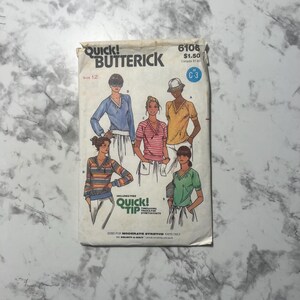 May include: A vintage sewing pattern for a women's top. The pattern is for a short-sleeved top with a V-neck. The pattern is from Quick & Easy Butterick and is size 12. The pattern is for moderate stretch knits only. The pattern number is 6106.