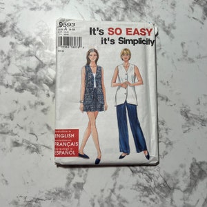 May include: A Simplicity sewing pattern packet, featuring illustrations of two women's outfits. The packet is white with the text "It's SO EASY it's Simplicity". The pattern number is 9593, size A 8-18. Instructions are in English, French, and Spanish.