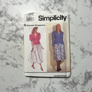 May include: Simplicity sewing pattern envelope featuring illustrations of women's outfits. The envelope is white with the Simplicity logo and pattern number 7369. The outfits include a jacket and skirt.