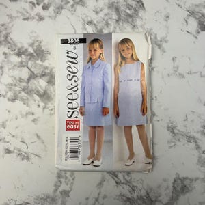 May include: A vintage See & Sew sewing pattern showing a light blue skirt suit and a sleeveless dress. The pattern, number 3806, includes the text "YES! It's easy". Sizes available are 8, 10, 12, and 14.