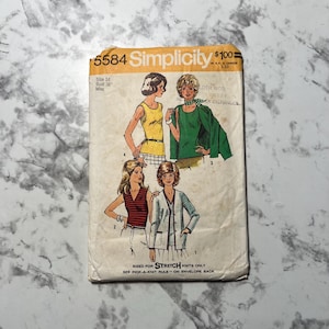 May include: Simplicity sewing pattern number 5584 for stretch knits. The pattern includes instructions for four garments: a sleeveless top, a long-sleeved top, a cardigan, and a skirt. The pattern is sized for a bust of 91.4 cm.