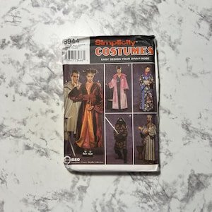 May include: Simplicity Costumes pattern featuring various robe designs. The package shows images of costumes, including a pink robe, a kimono, and a ninja outfit. The text "Easy Design Your Own Robe" is visible on the package.