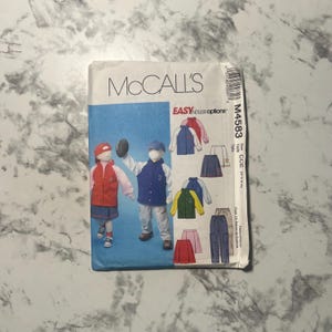 May include: McCall's sewing pattern for children's clothing, pattern number M4583, size CCE (3-4-0-0). The pattern includes instructions for making a variety of tops, pants, and skirts. The pattern is illustrated with drawings of children wearing the finished garments.