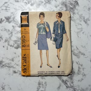 May include: Vintage McCall's sewing pattern for a women's dress and jacket ensemble. The pattern is printed on a yellow background with a black and white illustration of two women wearing the outfit. The pattern number is 8160 and the size is 22/43. The text on the pattern reads "Ensemble in women's sizes and misses' and women's half sizes."