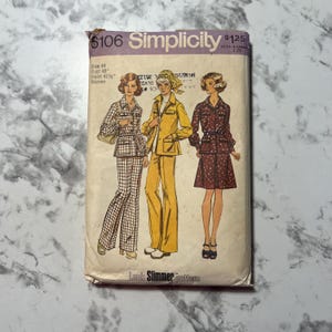 May include: Simplicity sewing pattern number 6106 for women's clothing. The pattern includes three different looks: a plaid pantsuit, a yellow jumpsuit, and a floral skirt and blouse. The pattern is for sizes 44 and up, with a bust measurement of 48 inches and a waist measurement of 41 1/2 inches. The pattern is priced at $1.25.
