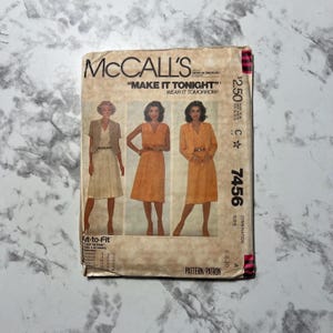 May include: McCall's sewing pattern envelope with the text "Make it Tonight! Wear it Tomorrow!" and the pattern number 7456. The envelope shows three women wearing different styles of dresses.