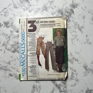 May include: A vintage McCall's sewing pattern for a set of pants, size 3, with instructions for making three different sizes. The pattern is for misses' sizes 12-14-16. The pattern cover features a line drawing of a woman wearing the pants.