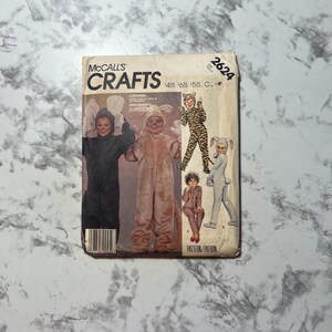 May include: McCall's Crafts sewing pattern number 2624 for children's costumes. The pattern includes instructions for making a bunny, cat, and tiger costume. The pattern is for sizes 4-8, 10-12, and 14-16.