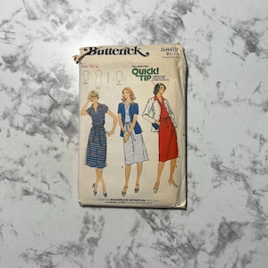 May include: Vintage Butterick sewing pattern 5862 featuring illustrations of three different dresses and jackets. The pattern includes the text "QUICK! TIP" and "FOR MODERATE STRETCH KNITS ONLY". The pattern is on a cream-colored background.