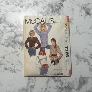 May include: Vintage McCall's sewing pattern envelope featuring illustrations of women's blouses. The envelope has the text "McCall's" and the pattern number "7726". The price is $2.75.