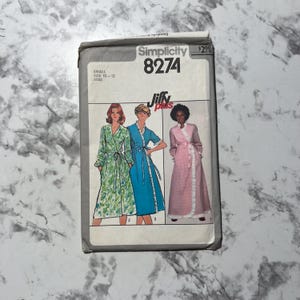 May include: Simplicity sewing pattern number 8274 for a Jiffy Plus size robe. The pattern is for sizes 10-12 misses. The pattern shows three different robes, one with a floral print, one in blue, and one in pink.