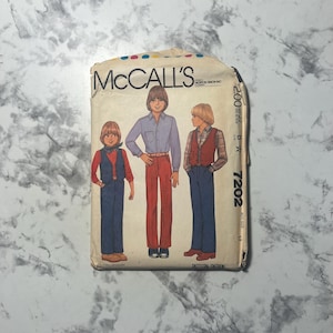 May include: Vintage McCall's sewing pattern featuring illustrations of three young people in various outfits. The pattern cover shows a boy in a button-down shirt and red pants, and two other boys in vests and pants. The pattern number is 7202.