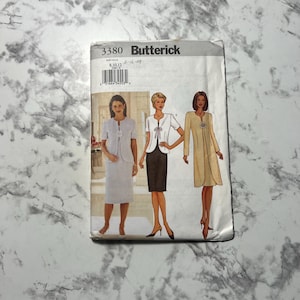 May include: A vintage Butterick sewing pattern packet featuring three women's suit designs. The packet is white with the number 3380 and the Butterick logo. The designs include a skirt suit, a jacket and skirt, and a long coat dress.