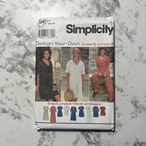 May include: Simplicity sewing pattern number 9407 for a dress and jumpsuit. The pattern includes instructions for designing your own dress and jumpsuit. The pattern is for sizes XS, S, and M. The pattern is shown on three models wearing different versions of the dress and jumpsuit.