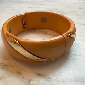 Vintage butterscotch plastic hinged bangle with gold metal accents