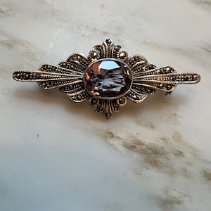 Vintage sterling silver marcasite bar brooch with amethyst colored stone