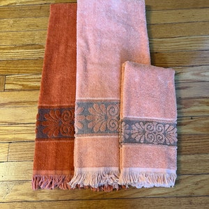 Vintage MCM bath towels and hand towel, 1 dark orange bath towel and 1 light orange bath towel, 1 light orange hand towel.