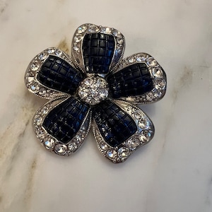 Vintage Nina Ricci for Avon sapphire invisible set rhinestone flower brooch