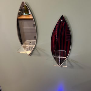 Vintage MCM mirrored lucite wall hanging shelves a pair. In good condition. 13” L X 4.5” W shelf is 3”X3”.