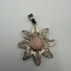 Sterling silver carved mother of pearl filigree flower pendant