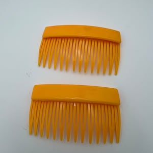 Vintage pair of yellow plastic hair combs made in France