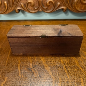 Antique set of Bakelite Dominoes-Simichrome tested- in original Antique wood box. Box is 7.5X2.5X2.5. Only 26 in box, 2 missing.
