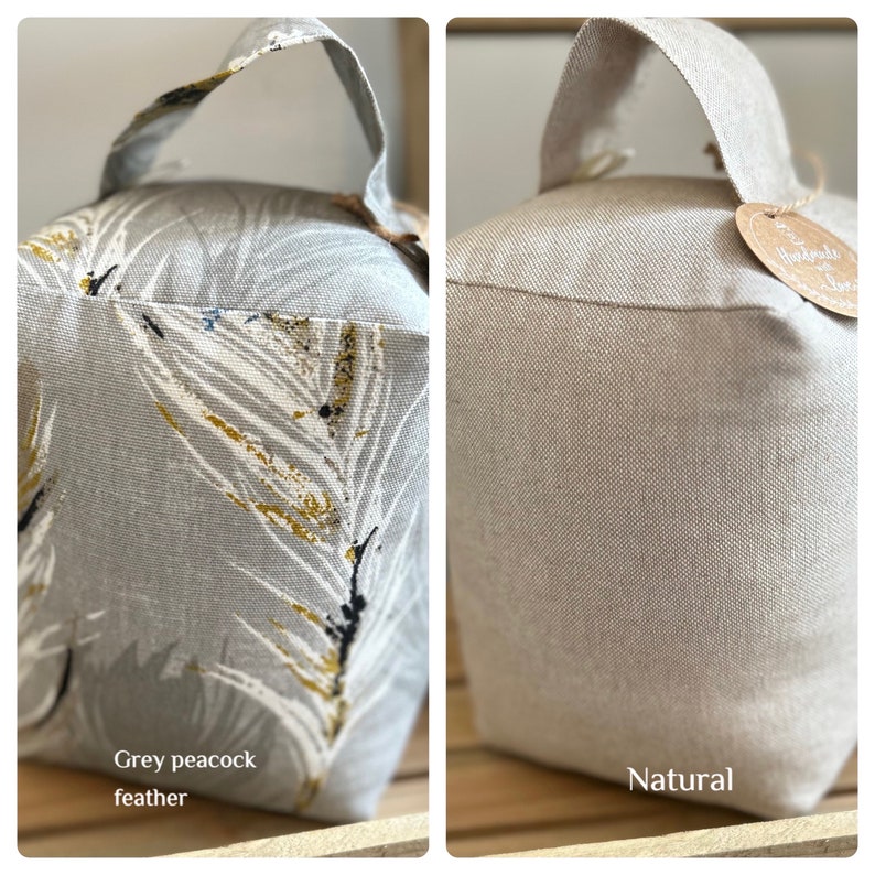 May include: Two doorstop cushions, one with a grey and white peacock feather pattern and the other in a natural beige fabric. Both have a loop handle.