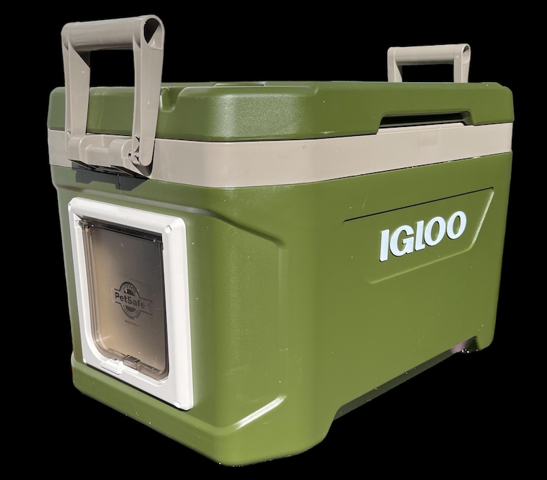 May include: Green Igloo cooler with a white PetSafe door on the side. The cooler has a beige lid and a white Igloo logo.