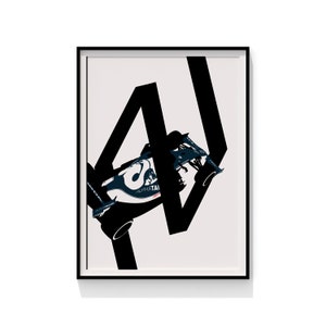 May include: Framed art print featuring a Formula 1 race car in navy blue and white, with the word "ALPHATAI" visible. The car is set against a cream background with large black geometric shapes. The artwork is in a black frame.