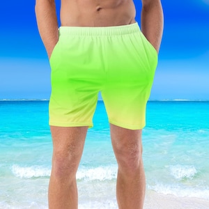 May include: A pair of green and yellow gradient swim trunks. The trunks have a drawstring waist and are made of a lightweight fabric.