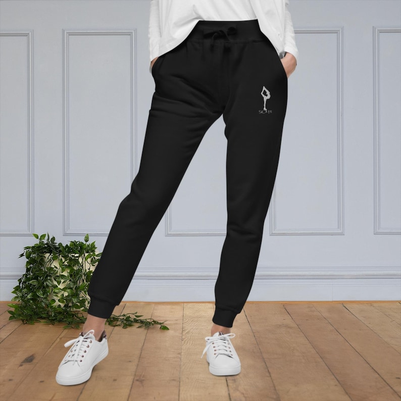 May include: Black sweatpants with a white graphic of a person doing a yoga pose and the text "Slay It".