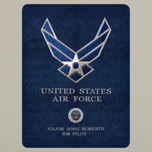May include: A navy blue rectangular design with the United States Air Force emblem in silver and blue. The text "UNITED STATES AIR FORCE" is above the name "MAJOR JOHN ROBERTS" and "B26 PILOT".