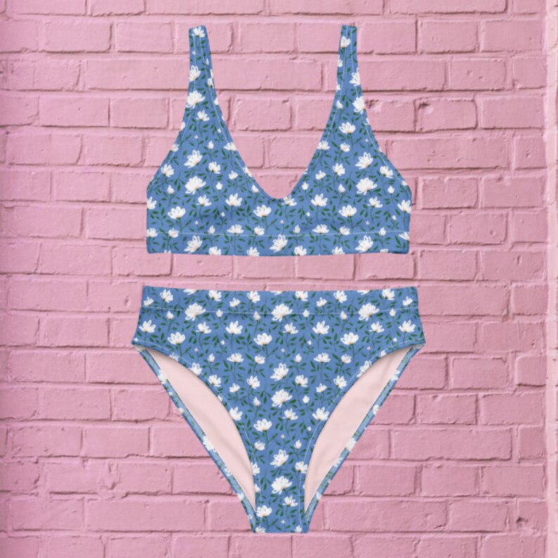 May include: A blue and white floral print bikini with a high-waisted bottom and a triangle top.