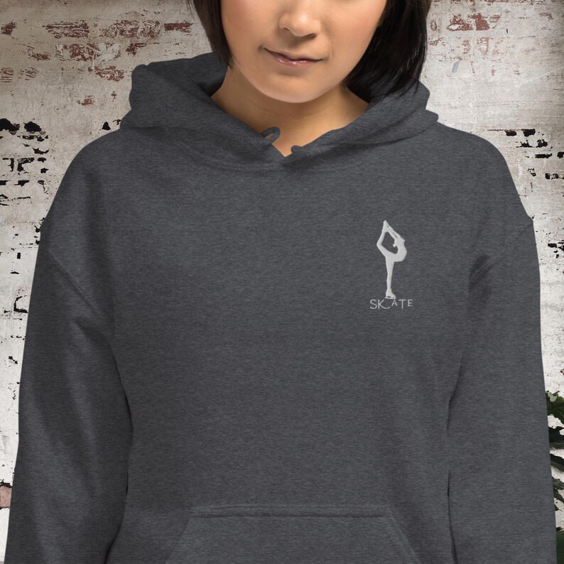 May include: A dark gray hoodie with a white silhouette of a figure ice skating and the word "SKATE" underneath.