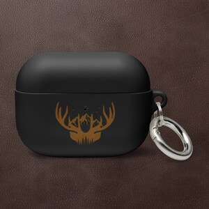 May include: Black silicone Airpods case with a gold deer silhouette design and a silver metal keychain.