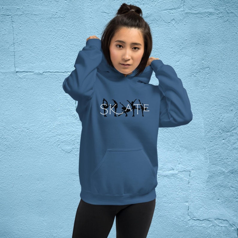 May include: A blue hooded sweatshirt with the word "SKATE" in white lettering and a silhouette of figure skaters in black.