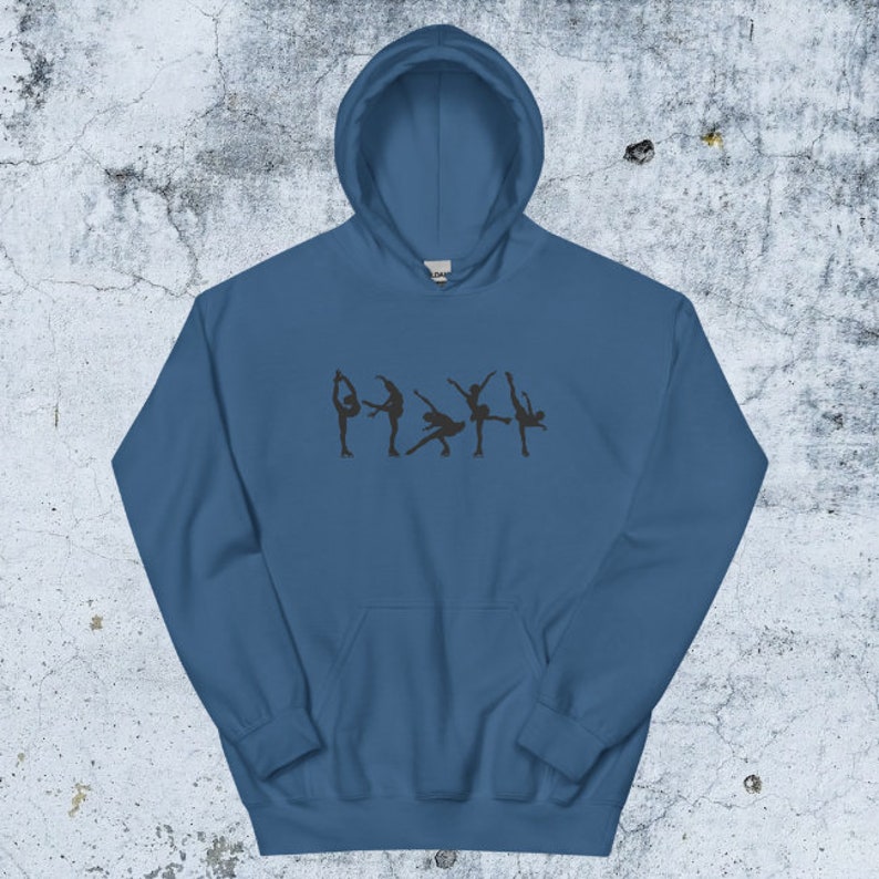 May include: A dark blue hooded sweatshirt with a graphic of five figure skaters in silhouette on the front.