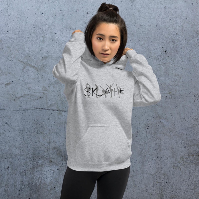 May include: A gray hoodie with a black graphic of ice skaters and the word "SKATE" printed on the front.