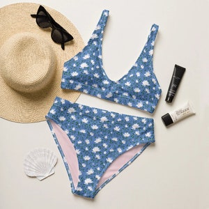 May include: A blue and white floral print bikini with a high-waisted bottom and a halter top.