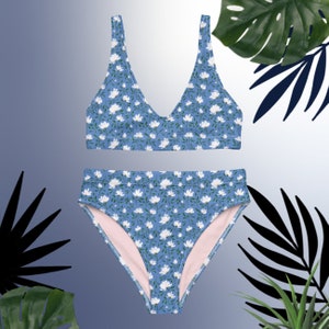May include: A blue and white floral print bikini with a high-waisted bottom and a v-neck top.