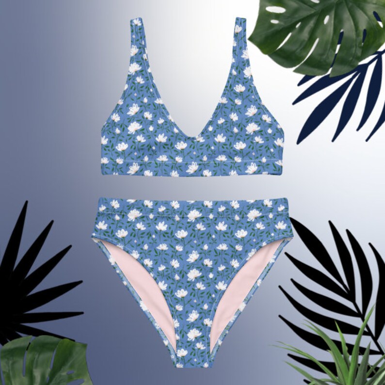 May include: A blue and white floral print bikini with a high-waisted bottom and a v-neck top.