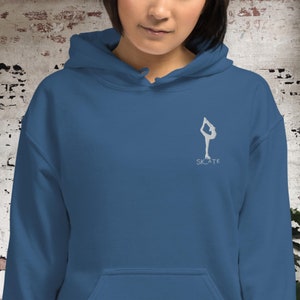 May include: A blue hoodie with a white silhouette of a figure ice skating and the word "SKATE" underneath.