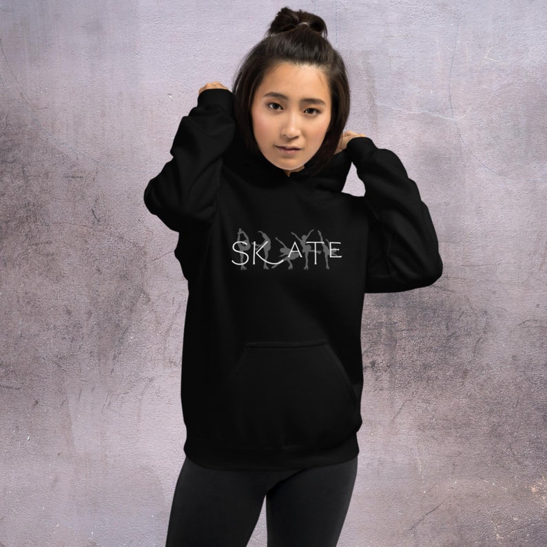 May include: Black hoodie with a white graphic of stylized figures skating and the word "SKATE" in white letters.