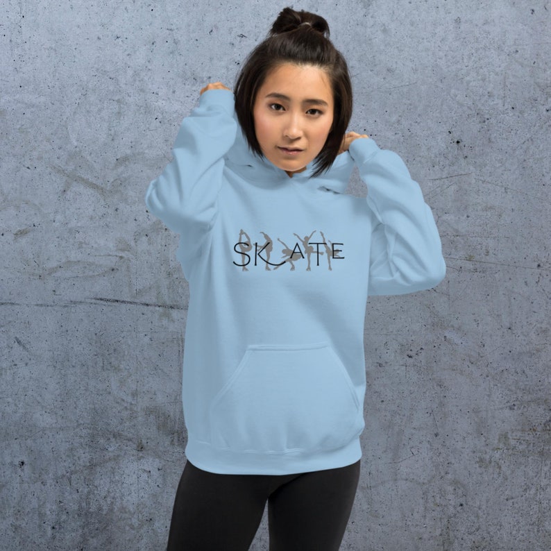 May include: A light blue hoodie with a black graphic of ice skaters and the word "SKATE" printed on the front.