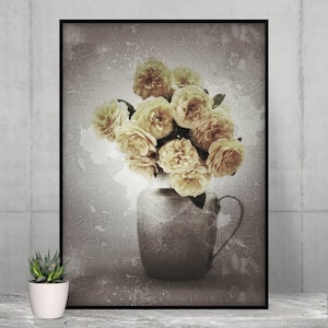 May include: A framed print featuring a still life of yellow roses in a rustic vase. The vase has a handle and is set against a textured, sepia-toned background. A small potted succulent is in the foreground.