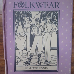 May include: A vintage sewing pattern titled "FOLKWEAR" with an illustration of three figures in vintage clothing. The cover is lavender with a repeating white dot pattern. The words "PALM BEACH PANTS" are printed at the bottom.