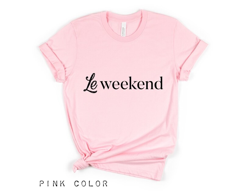 May include: A pink t-shirt with the text "Le weekend" in black lettering.